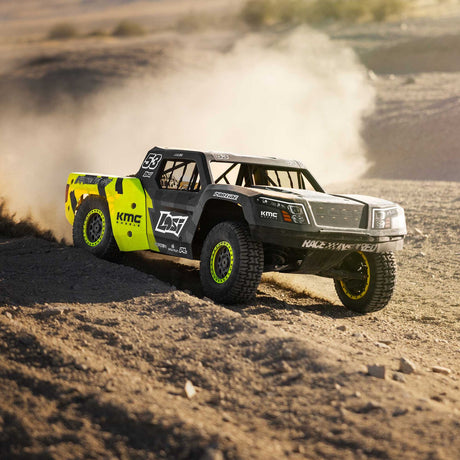 Losi short course truck throwing dust on a desert trail — Cars & Trucks at RC Hobby Pros
